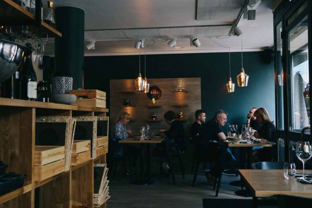 Kajo restaurant in Tampere. The interior of Kajo restaurant, featuring hung lighting and tables of diners.