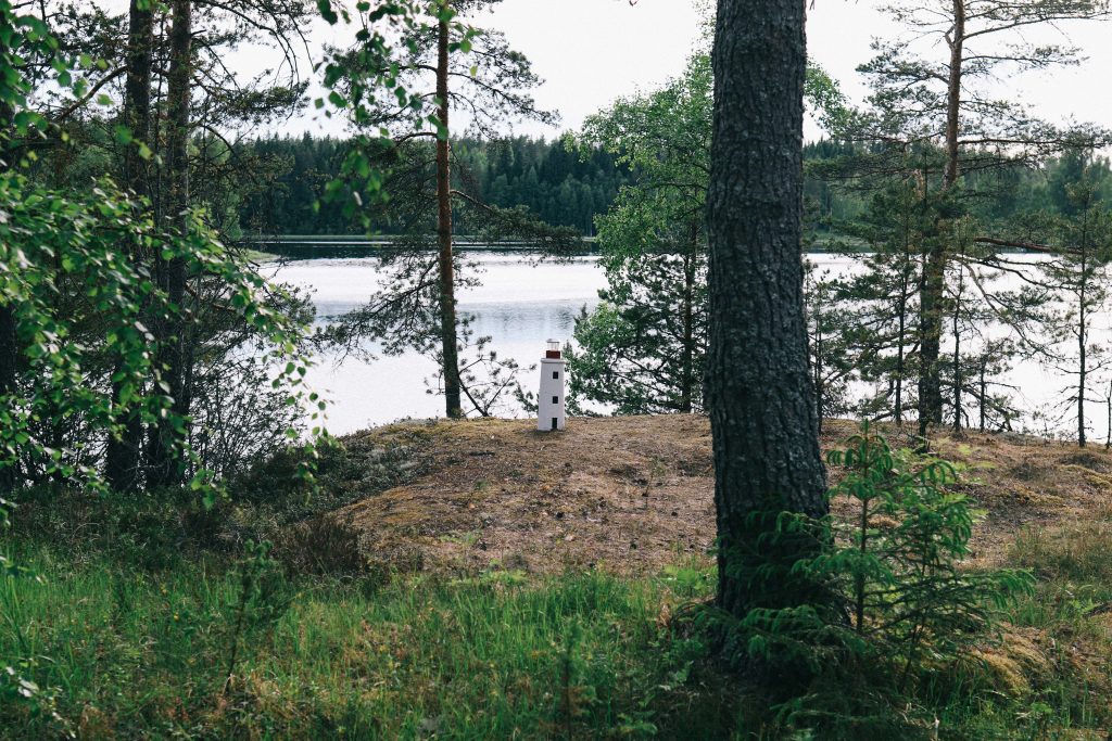 Our cottage via Mokkiavain Cottages. A small statue of a lighthouse, overlooking a Finnish lake in Tampere.